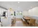 Open-concept kitchen and dining room with an island and a large wooden dining table at 1476 Harbour Walk Rd, Tampa, FL 33602