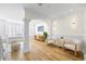 Open-concept living room with hardwood floors, white walls, and stylish furnishings at 1476 Harbour Walk Rd, Tampa, FL 33602