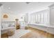Bright living room with white couches, window seating, and hardwood flooring at 1476 Harbour Walk Rd, Tampa, FL 33602