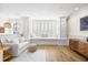 Bright living room with white furnishings, hardwood floors, and a built-in window seat at 1476 Harbour Walk Rd, Tampa, FL 33602