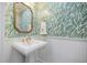 Powder room boasts designer wallpaper, a pedestal sink, and modern fixtures at 1476 Harbour Walk Rd, Tampa, FL 33602