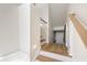 Staircase landing featuring hardwood floors, white walls, and light fixtures at 1476 Harbour Walk Rd, Tampa, FL 33602