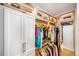 Spacious walk-in closet with custom shelving, ample hanging space and upper glass storage at 1476 Harbour Walk Rd, Tampa, FL 33602