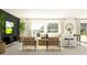 Well-lit living room with modern decor, plush seating, and a sleek entertainment center at 15262 Rainbow Quartz St, Wimauma, FL 33598