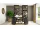 Home office with black desk, shelves, and natural light, creating a productive workspace at 15262 Rainbow Quartz St, Wimauma, FL 33598
