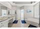 Bright bathroom with a soaking tub, double vanity, and a large window at 15428 Atwater Dr, Brooksville, FL 34604