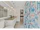 Bathroom featuring modern fixtures, granite countertop, and fun shower curtain providing a bright and functional space at 15428 Atwater Dr, Brooksville, FL 34604