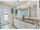 Bright bathroom with white cabinets, granite countertop, and access to the pool area at 15428 Atwater Dr, Brooksville, FL 34604