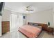 Inviting bedroom with neutral decor, fan, and a large window at 15428 Atwater Dr, Brooksville, FL 34604