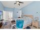 Cozy bedroom featuring a ceiling fan, neutral decor, and ample natural light at 15428 Atwater Dr, Brooksville, FL 34604