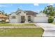 Charming single-story home with a well-manicured lawn, beautiful stone accents, and a two-car garage at 15428 Atwater Dr, Brooksville, FL 34604