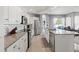 Modern kitchen with stainless steel appliances, granite countertops, island, and a subway tile backsplash at 15428 Atwater Dr, Brooksville, FL 34604