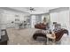 Spacious living area with a comfortable chaise lounge, modern kitchen, and desk setup at 15428 Atwater Dr, Brooksville, FL 34604