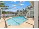 Inviting screened-in pool with clear blue water, surrounded by a spacious deck, offering a private backyard oasis at 15428 Atwater Dr, Brooksville, FL 34604