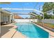 Sparkling swimming pool enclosed by a screen, surrounded by well-maintained landscaping, offering a private retreat at 15428 Atwater Dr, Brooksville, FL 34604