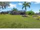 Large backyard showcases a screened-in pool area, well-maintained lawn, and serene surroundings at 15635 Starling Water, Lithia, FL 33547