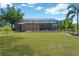 Expansive backyard features a screened-in pool area, lush green lawn, and a peaceful outdoor space at 15635 Starling Water, Lithia, FL 33547