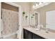 Neutral bathroom featuring a shower-tub combo with floral curtain and a vanity with a white sink at 15635 Starling Water, Lithia, FL 33547