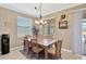 Cozy dining area with backyard views, a modern light fixture, and seating for six at 15635 Starling Water, Lithia, FL 33547
