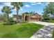 Beautiful home showcasing lush green lawn, landscaping, and a three-car garage, creating a welcoming entrance at 15635 Starling Water, Lithia, FL 33547