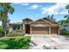 Inviting home with a well-manicured lawn, three-car garage, and mature landscaping at 15635 Starling Water, Lithia, FL 33547