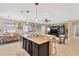 Open-concept kitchen and living area with bar seating and a view to the backyard at 15635 Starling Water, Lithia, FL 33547