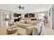 Open-concept living room featuring plush seating, dark cabinetry, and a seamless flow to the dining area at 15635 Starling Water, Lithia, FL 33547