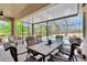 Covered and screened patio features ample seating, a dining table, and a beautiful view of the pool at 15635 Starling Water, Lithia, FL 33547