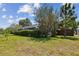 The backyard showcases beautiful landscaping and a screened enclosure for enjoying the outdoors at 16503 W Course Dr, Tampa, FL 33624