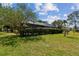 Private backyard with a screened enclosure, perfect for relaxation and outdoor enjoyment at 16503 W Course Dr, Tampa, FL 33624