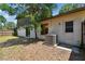 This backyard features a home exterior with updated windows, doors, and a modern HVAC system at 16503 W Course Dr, Tampa, FL 33624