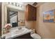 Charming powder room features vanity with a marble countertop, mirror, vanity lighting, and a toilet at 16503 W Course Dr, Tampa, FL 33624
