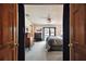 Comfortable bedroom with a sliding glass door to a balcony, dresser, tv and ceiling fan at 16503 W Course Dr, Tampa, FL 33624