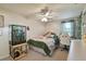 Inviting bedroom features natural light, decorative plants, ceiling fan and a cozy bed at 16503 W Course Dr, Tampa, FL 33624