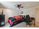 Comfortable bedroom featuring a fan, window, gaming desk, and ample space at 16503 W Course Dr, Tampa, FL 33624