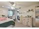 Comfortable bedroom features storage with a large dresser, ceiling fan, and natural light at 16503 W Course Dr, Tampa, FL 33624