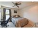 Inviting bedroom with cozy bed, ceiling fan, natural light, and dedicated desk space at 16503 W Course Dr, Tampa, FL 33624