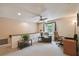 Cozy bonus room features neutral paint, ceiling fan, and comfortable seating area near the window at 16503 W Course Dr, Tampa, FL 33624