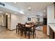 Bright dining area connected to living room, with wood-look tile flooring and ample lighting at 16503 W Course Dr, Tampa, FL 33624