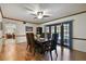 Sunlit dining room with hardwood floors and a view of the backyard through French doors at 16503 W Course Dr, Tampa, FL 33624