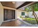 Inviting entryway featuring a decorative front door, tiled flooring, and access to a front garden at 16503 W Course Dr, Tampa, FL 33624