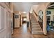 Welcoming foyer with tiled floor, staircase, and views into the living and dining spaces at 16503 W Course Dr, Tampa, FL 33624