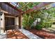 Inviting front porch featuring a pergola, tiled flooring and a decorative front door at 16503 W Course Dr, Tampa, FL 33624