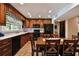 The kitchen features wooden cabinets, black appliances and adjacent dining area at 16503 W Course Dr, Tampa, FL 33624