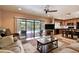 Open concept living room with access to kitchen, dining area, and a view of the pool at 16503 W Course Dr, Tampa, FL 33624