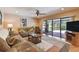 Inviting living room with sliding glass doors, comfortable seating, and backyard views at 16503 W Course Dr, Tampa, FL 33624