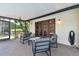 Inviting screened patio with a cozy seating arrangement and direct access to the backyard at 16503 W Course Dr, Tampa, FL 33624