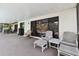 Covered patio area with comfortable seating, ideal for outdoor relaxation at 16503 W Course Dr, Tampa, FL 33624