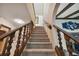 Carpeted staircase with wood banister and spindles, leading up to the next level of the home at 16503 W Course Dr, Tampa, FL 33624
