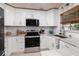 Bright kitchen features white cabinets, stainless steel appliances, and ample counter space for cooking at 180 58Th Ave, St Pete Beach, FL 33706